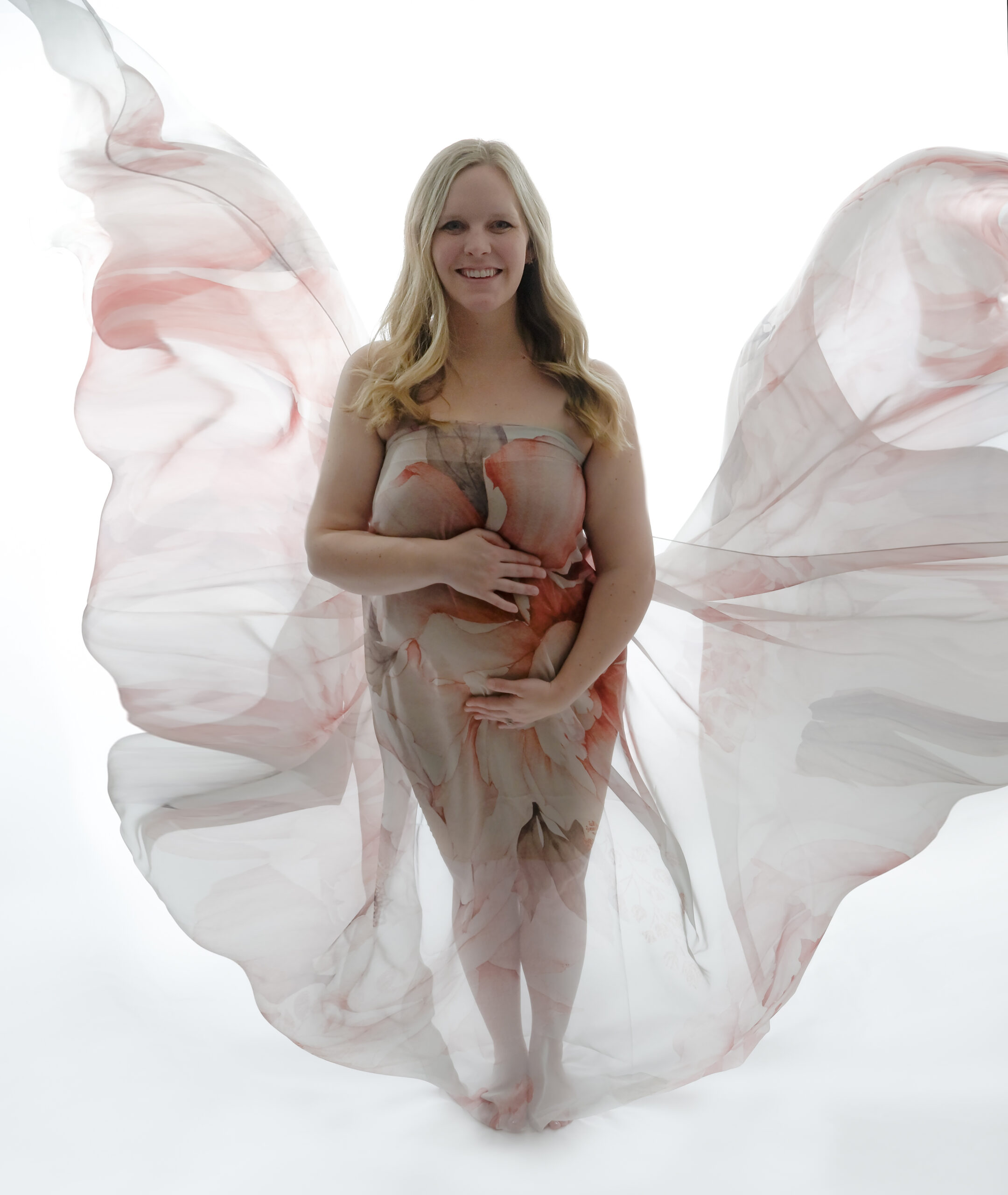 Kitsap mom to be draped in floral chiffon fabric for a fabric toss during her maternity photo session