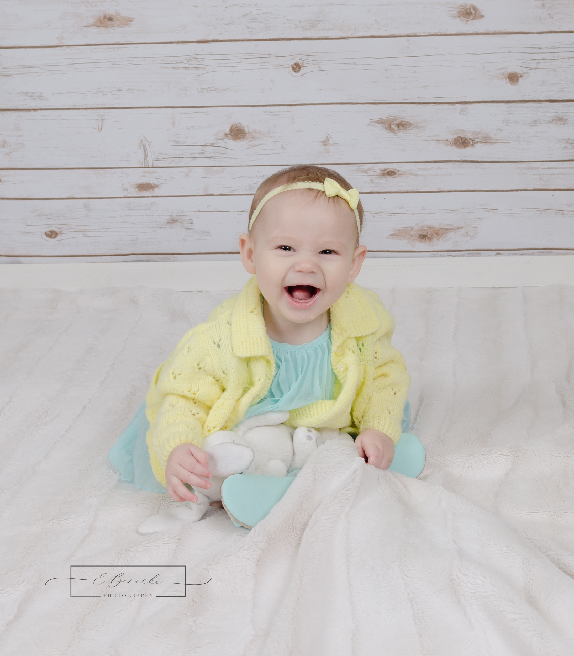 Adorable baby girl laughing during her children's photo session by E. Benecki Photography