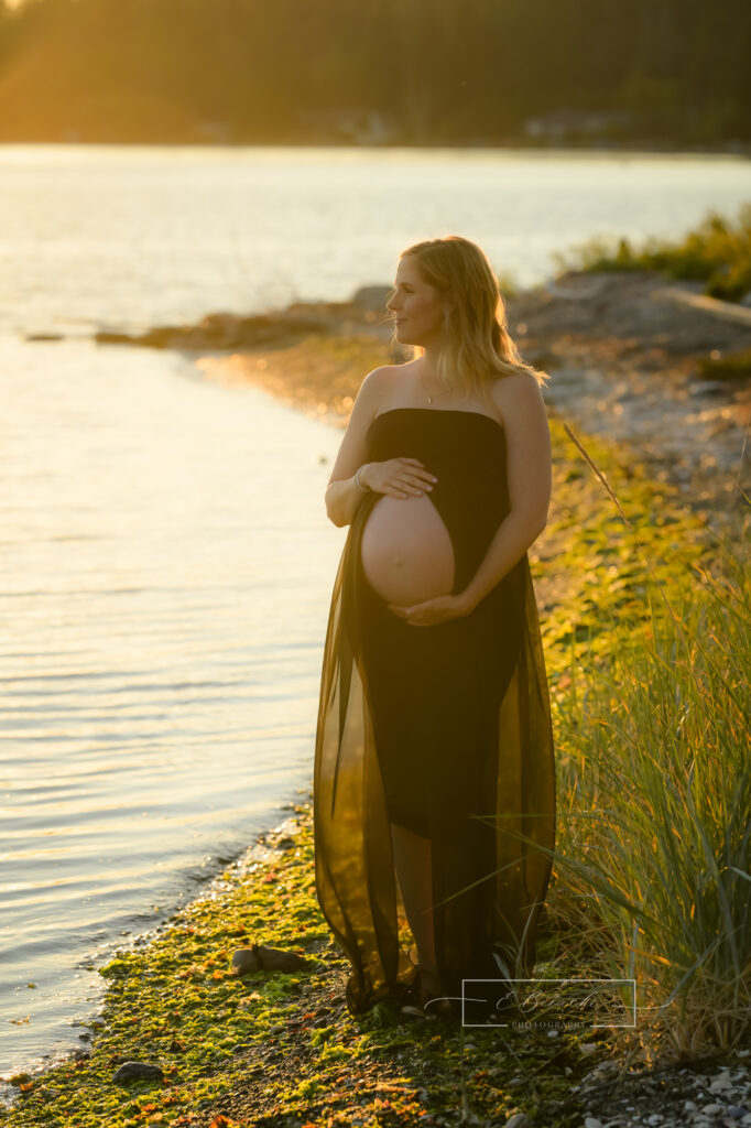 Bainbridge beach maternity session at sunset with mom to be silhouetted in the golden sun.